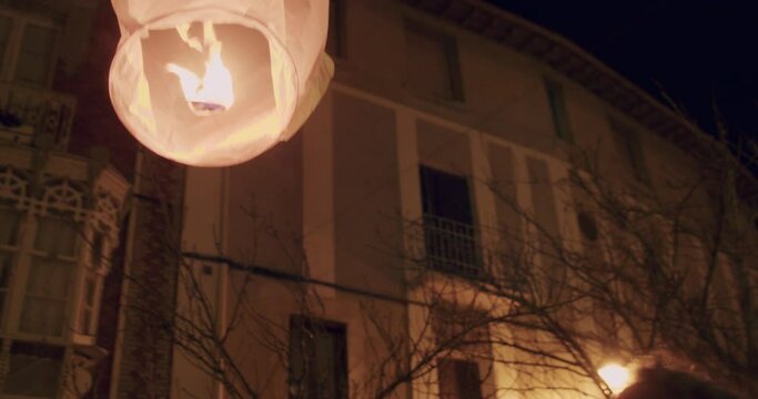 paper lantern release by woman hands in night festival