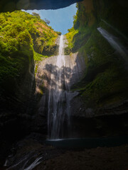 View of Madakaripura waterfall from a cave in East Java, Indonesia