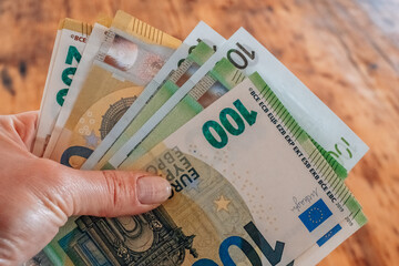  euro bills. Hands counting out euro money on the table.European Union money.euro banknotes in...