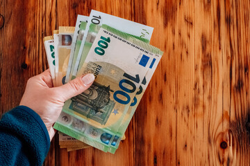 One hundred euro bills. Hands counting out euro money on the table.European Union money.euro...