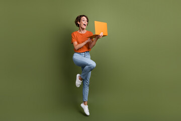 Full length photo of astonished ecstatic girl in stylish clothes look at laptop make online order...