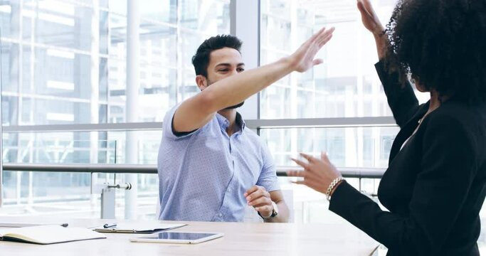 Happy business people, high five and applause in office for promotion, teamwork or success together. Businessman and woman touching hands or clapping for team achievement, sale or deal at workplace