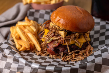 Homemade fresh meat burgers with potato bread with egg bacon tomato lettuce onion cheddar cheese ham dressings different varieties with fries fast food