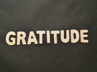Gratitude text, written on wooden lettering, balance in life