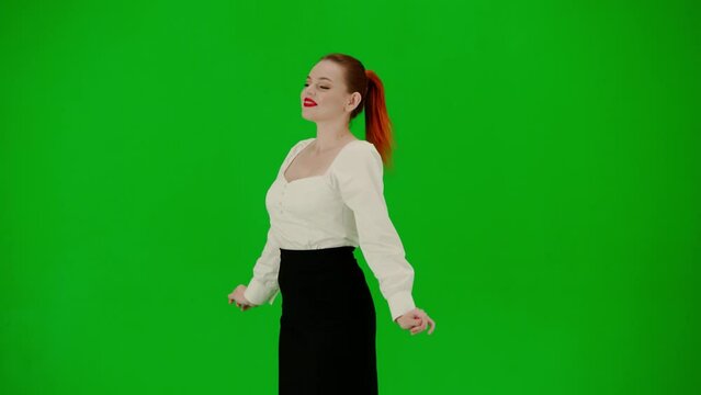 Portrait of attractive office girl on chroma key green screen. Woman in skirt and blouse posing with cute smiling face and doing little jump.