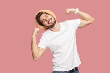 Portrait of satisfied delighted smiling positive optimistic bearded man in white T-shirt and hat...