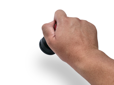 Hand holding red handled round rubber stamp, top view isolated on white