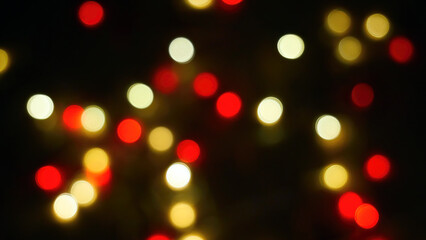 Defocused blurry multicolored blinker lights bokeh of Christmas and New year decoration lights, abstract, dark background, overlay for party, shallow DOF, festive mood