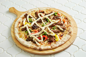 pizza on a wooden board	