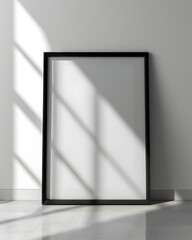 Portrait blank white picture frame standing on the floor with sunlight, on white background for mock up, copy space.