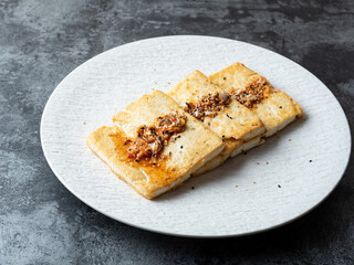 Seasoned grilled tofu on a plate