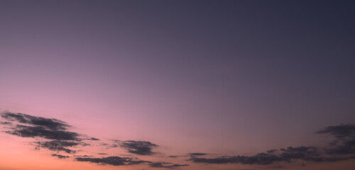 Obraz premium Panoramic view of clear blue sky and clouds, Blue sky background with tiny clouds. White fluffy clouds in the blue sky. Captivating stock photo featuring the mesmerizing beauty of the sky and clouds.