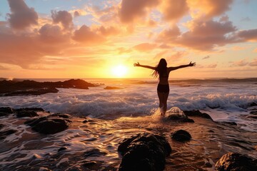 A successful professional finds solace and celebration at the beach, her arms open towards the sunrise as she embraces the opportunities and challenges of a new day. - obrazy, fototapety, plakaty