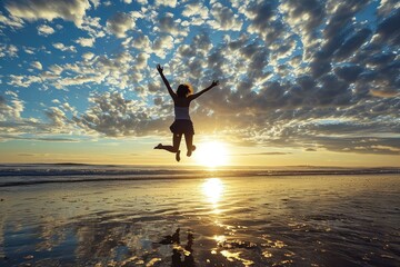 A successful woman leaps joyfully on the beach at dawn, her arms open wide to the rising sun, celebrating her achievements and the promise of a new day. - obrazy, fototapety, plakaty