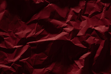 Red old crumpled paper texture in low light background,wrinkled paper