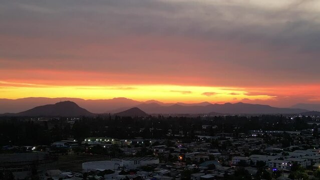 the sun descending over the coastal mountain range, country of chile