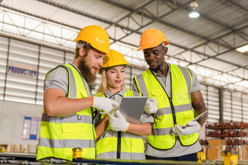 Female and African American male workers use tablets to work in warehouses, engineer teams shipping...