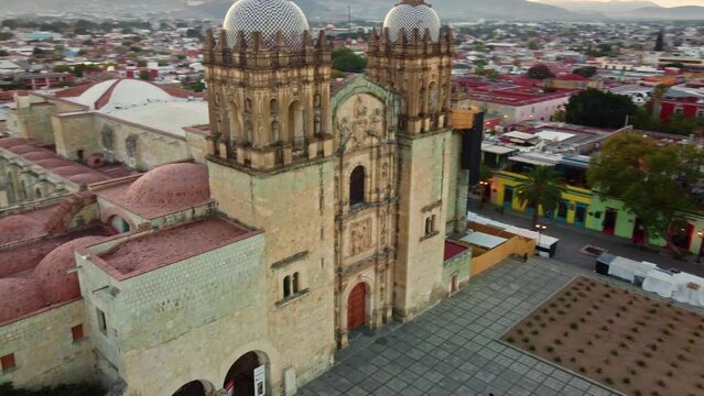 backwards drone shot of Santo Domingo temple in downtown Oaxaca city in Mexico