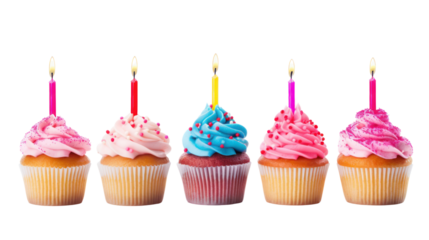 Colorful birthday cupcakes with candles and toppings