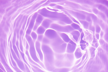  Purple water splashes on the surface ripple blur. Defocus blurred transparent pink colored clear calm water surface texture with splash and bubble. Water waves with shining pattern texture background