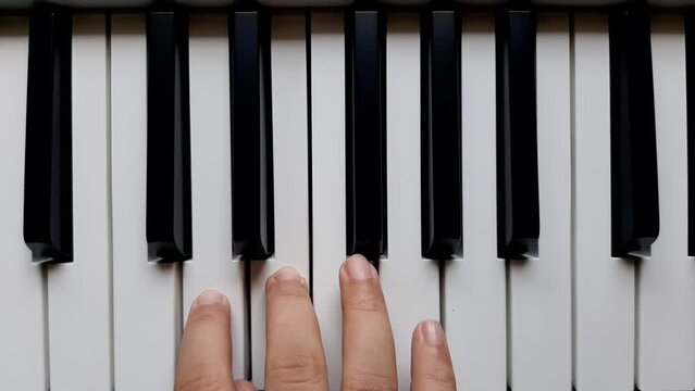 A beginner practicing right hand in playing notes on the piano