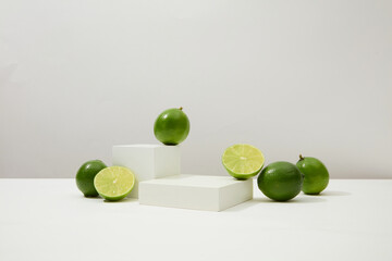 Vibrant green lemons pop against a white backdrop with a centered podium. A potent skin-beautifying...
