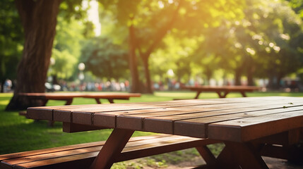 wood picnic tables in the park blurry background - obrazy, fototapety, plakaty