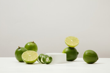 Prominent green limes on a white backdrop with a central round platform. Rich in L-ascorbic acid,...