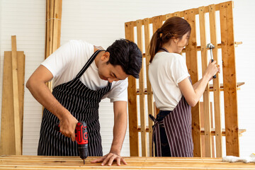 Carpenter drilling holes in woodwork with electric drill
