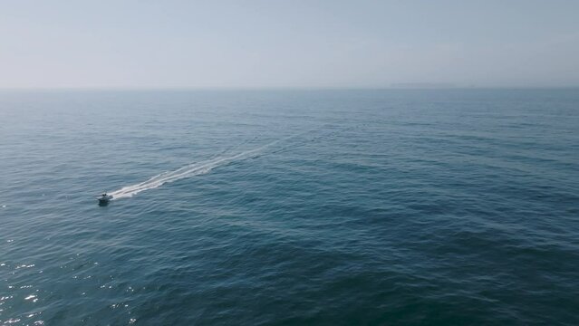 drone shot of boat moving fast in the sea