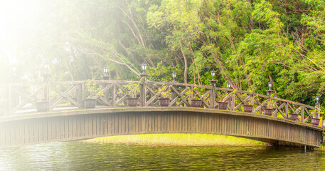 Beautiful wooden bridge across river on soft sunlight