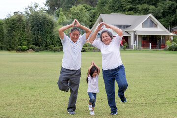 Healthy family with yoga poses exercising on the grass at grandpa and grandma house with granddaughter. lovely moment