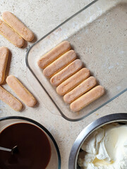 directly above shot of ingredients for making tiramisu with biscuits stone table
