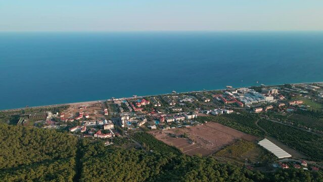 Aerial 4K drone footage of Kemer, Antalya, Turkey. Mesmerizing turquoise Mediterranean sea, cityscape, and mountains &ndash; a captivating visual asset captured in vibrant summer.time.