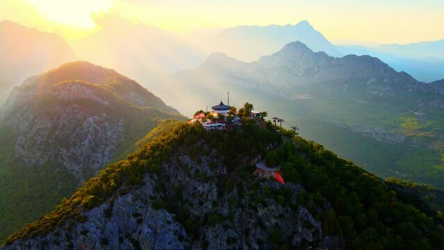 Aerial 4K drone video of a Tunektepe Teleferik
Cable station positioned on top of the hill with the mountains in the background. View point and attraction located in Antalya, Turkey.