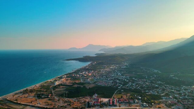 Aerial 4K drone footage of Kiriş-
Kemer (Antalya, Turkey). Mediterranean sea, beach, cityscape (hotels and resorts), and mountains &ndash; a captivating sunset captured in vibrant summer.time.