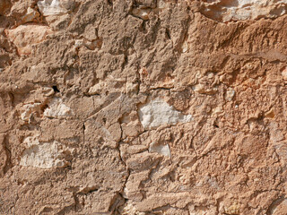 Distressed wall surface. Grunge brown and orange stone wall