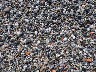 Background of colorful pebbles on the sand beach