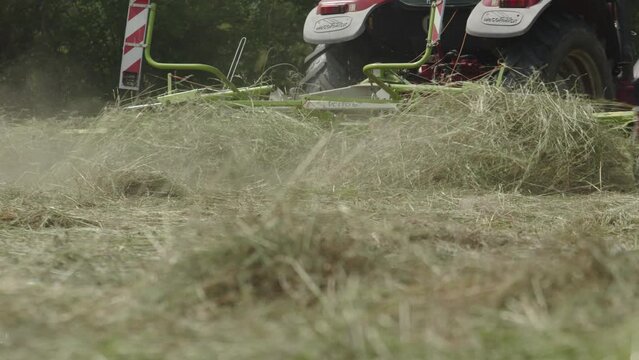 Farm Machine Tractor With Rotating Rake Attachments. Close Up Shot