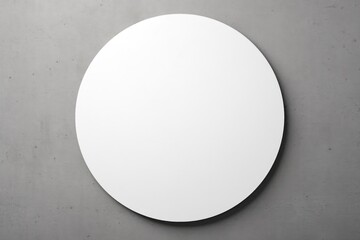 A mock-up of a round white sticker on a concrete background