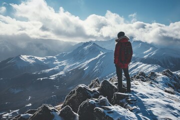 Fototapeta premium Sunrise triumph: A happy man reaches new heights, standing tall on a mountain summit, embracing the morning glow.