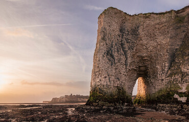 Sunrise at low tide at the sea stacks and chalk cliffs of Botany Bay on the north east coast of...