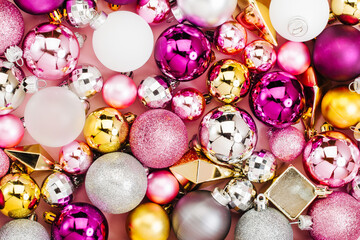 Holiday  arrangement with Stylish Christmas shiny baubles and gold crystals on pastel pink...