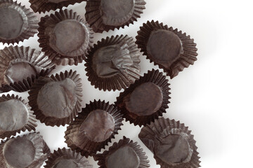 Close view of empty brown cups for chocolate candy on white background with copy space