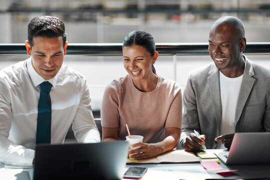 Smiling group of diverse businesspeople working at a table together