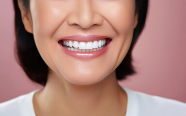 beautiful healthy smile and teeth of asian woman closeup on pink background