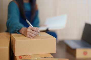 Asian female business owner handles delivery of orders to customers