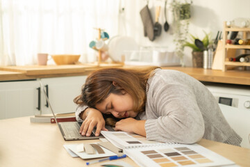 People, job, modern electronic gadgets and technologies.  young overweight lay on table tired with overwhelm work brunette woman freelancer doing her work designer at home .