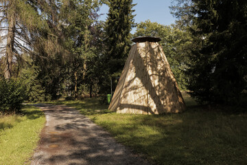 Wooden teepee building hut in park surrounded by trees in the town called Braunlage, Lower Saxony,...