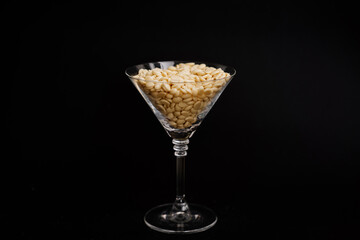 hot depilation white wax granules in glass on black background. beauty industry, body care....